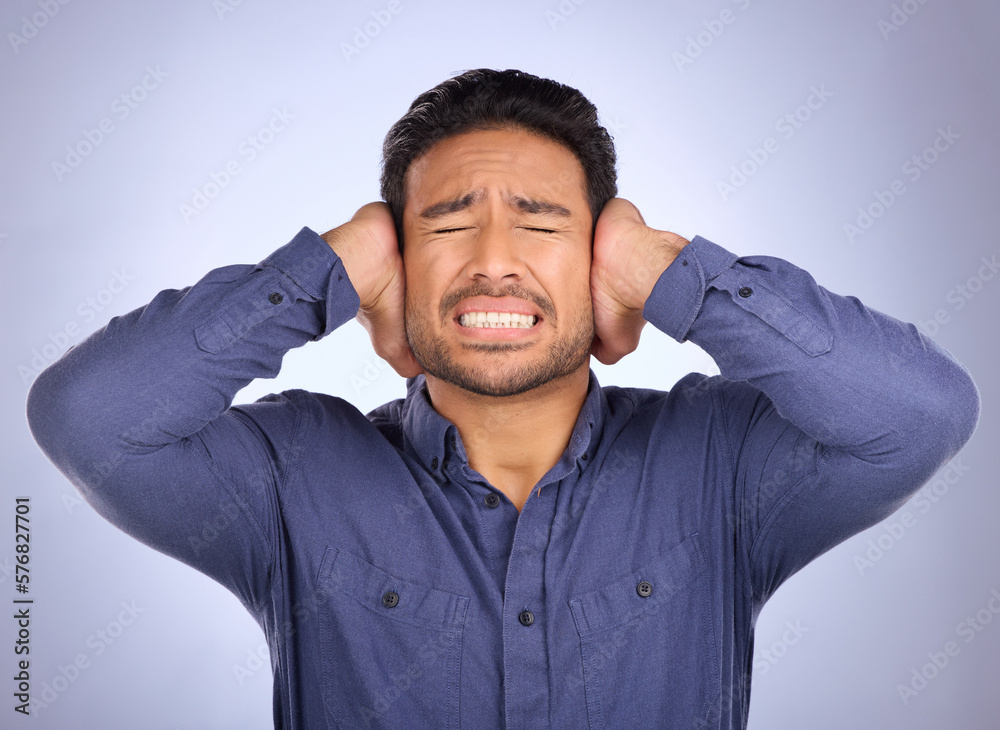 Stress, noise and man closing his ears in studio isolated on a gray background. Loud, mental health and upset, angry or mad business person with headache, depression or anxiety from noisy sound. Stress, noise and man closing his ears in studio isolated on a gray background. Loud, mental health and upset, angry or mad business person with headache, depression or anxiety from noisy sound.