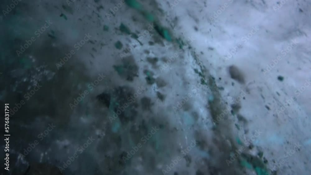 Powder Ice Color Turquoise pure color of ice inside the ice cave. Stones and icicles are ...