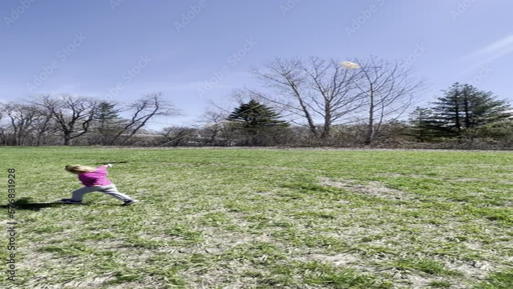 vertical video of a preschool girl in pink jacket flying a kite vertical video of a preschool girl in pink jacket flying a kite