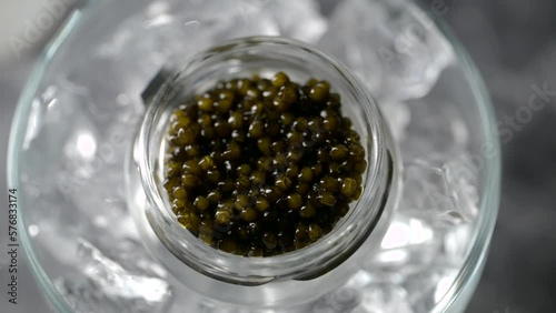  black caviar on ice with pearl spoon
