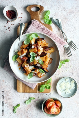 Pasta alla norma - Italian pasta with eggplant, tomato sauce and parmesan cheese. Top view.