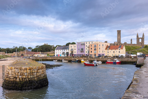 The entrance to the picturesque harbour of St Andrews in Fife on the east coast of Scotland. The St Rules Tower and cathedral ruins  in the background. photo