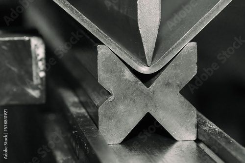 Metal bending process, sheet metal is bent on a hydraulic machine. Bending of sheet metal of different thicknesses.