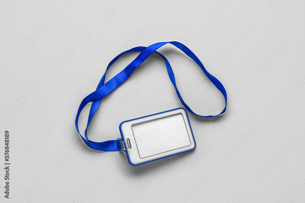 Blank badge with blue lanyard on grey background Blank badge with blue lanyard on grey background