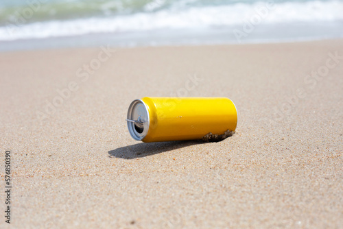 Yellow can waste on the beach