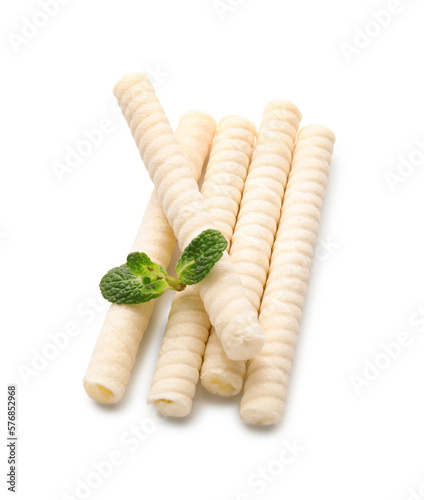 Delicious wafer rolls and mint isolated on white background