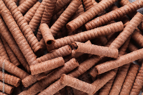 Delicious chocolate wafer rolls as background