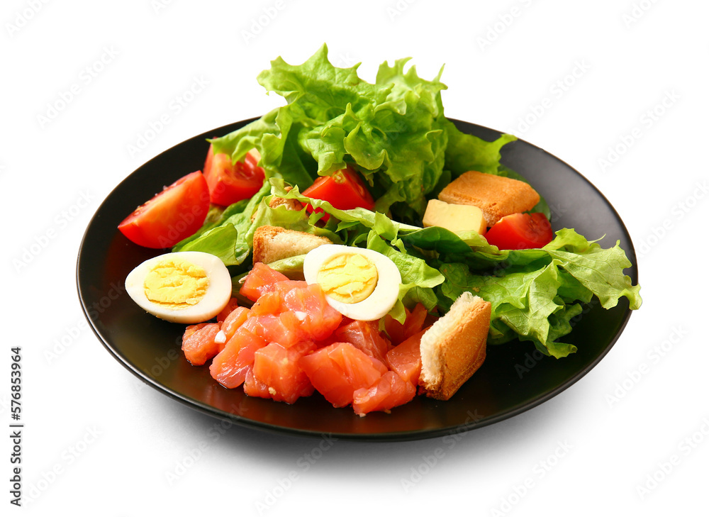 Plate of delicious salad with boiled  eggs and salmon on white background