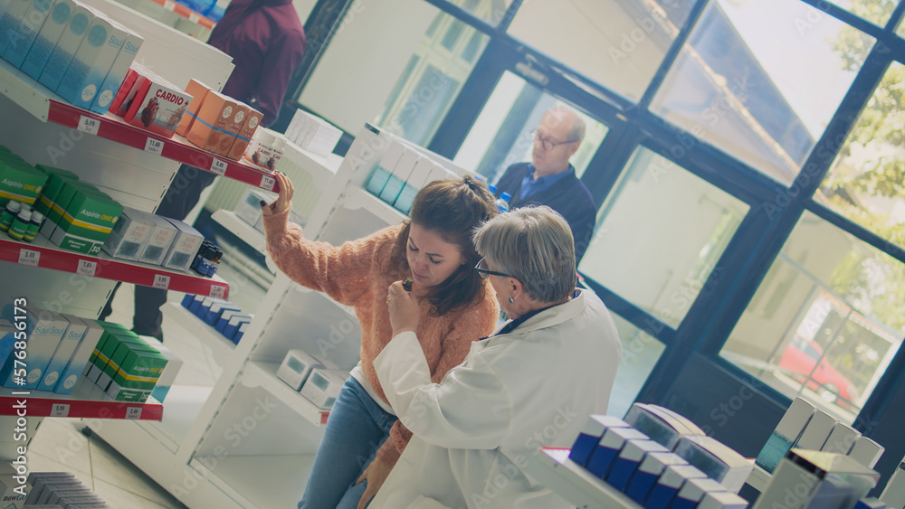 Female client losing balance and feeling dizzy in drugstore, asking for