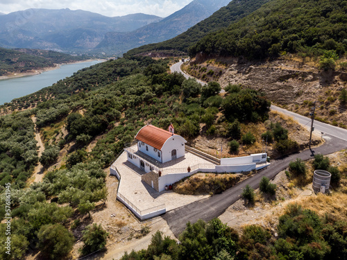 Heraklion, Crete Greece August 22, 2022: The new Orthodox church of Agios Theodoros of the village of Sfendyli, at Aposelemi Dam in Heraklion. Aerial drone shot.