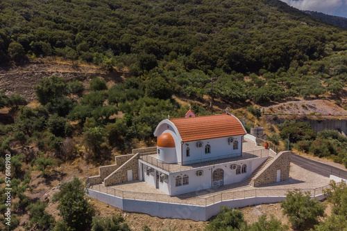 Heraklion, Crete Greece August 22, 2022: The new Orthodox church of Agios Theodoros of the village of Sfendyli, at Aposelemi Dam in Heraklion. Aerial drone shot.