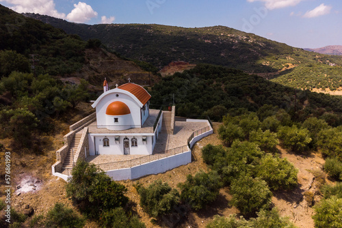 Heraklion, Crete Greece August 22, 2022: The new Orthodox church of Agios Theodoros of the village of Sfendyli, at Aposelemi Dam in Heraklion. Aerial drone shot.
