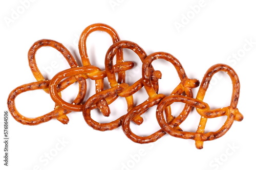 Salted pretzels pile, party snacks isolated on white, top view