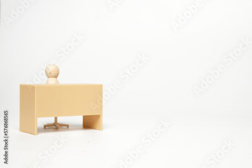 Selective focus picture of office peg table with peg doll on isolated white background