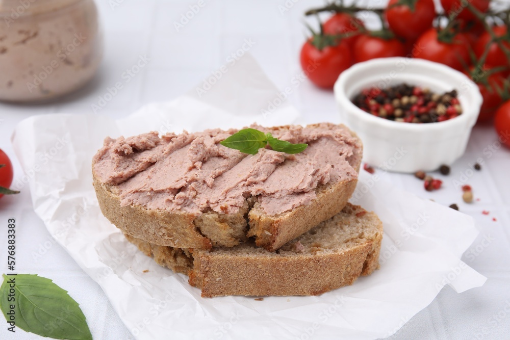 Delicious liverwurst sandwich with basil on white table Delicious liverwurst sandwich with basil on white table