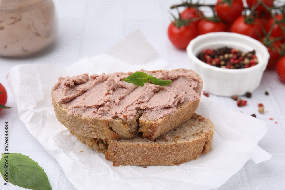 Delicious liverwurst sandwich with basil on white table