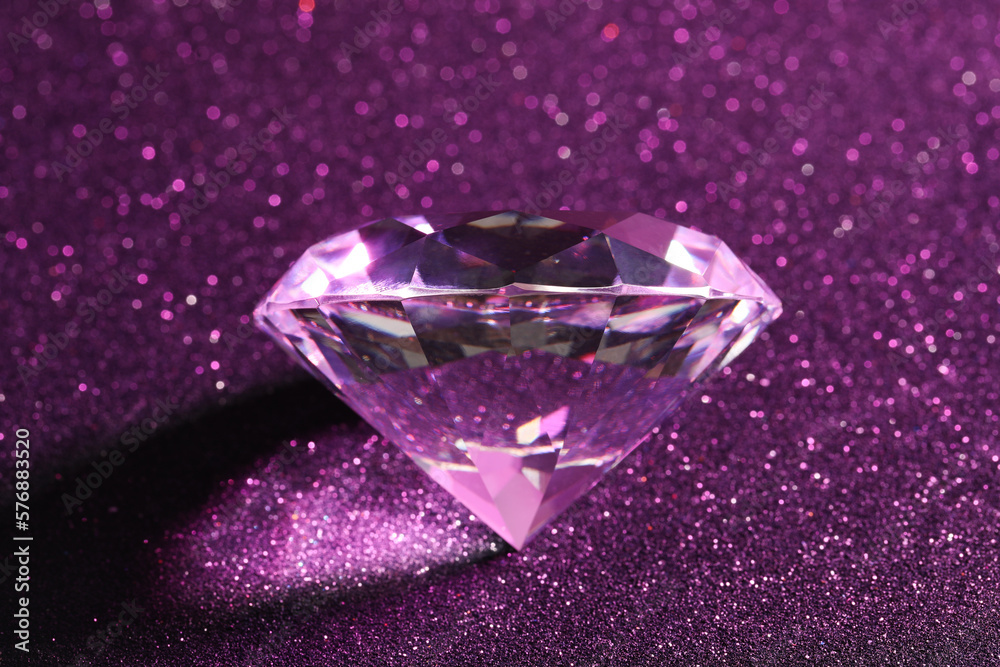 Beautiful shiny diamond on purple glitter background, closeup Beautiful shiny diamond on purple glitter background, closeup