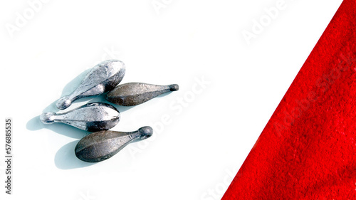 Fishing line sinkers on a white background with a red graphic photo