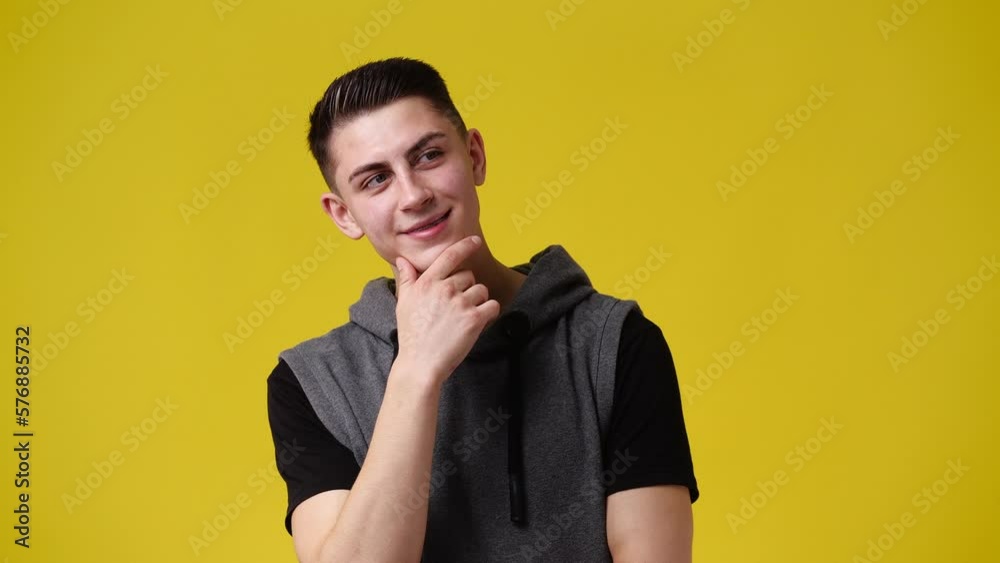 4k video of a man thinking about something over yellow background. 4k video of a man thinking about something over yellow background.