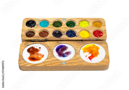 Wooden watercolor palette. Watercolor tray with watercolor set isolated on a white background.