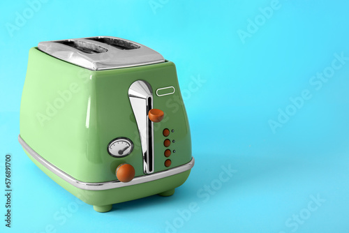 Modern toaster on blue background