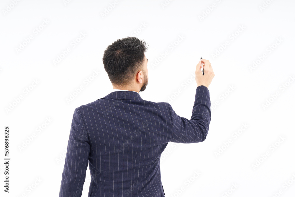 A man in a suit posing to write with a pen A man in a suit posing to write with a pen