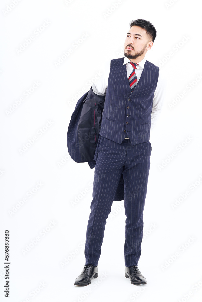 A man in a suit taking off his jacket A man in a suit taking off his jacket