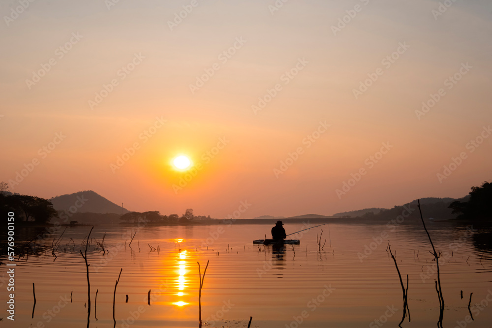 Fishermen fishing boats in the reservoir during sunrise. Harirak Forest Park Huai Nam Man Reservoir, Loei, Thailand, 21 Feb 2023