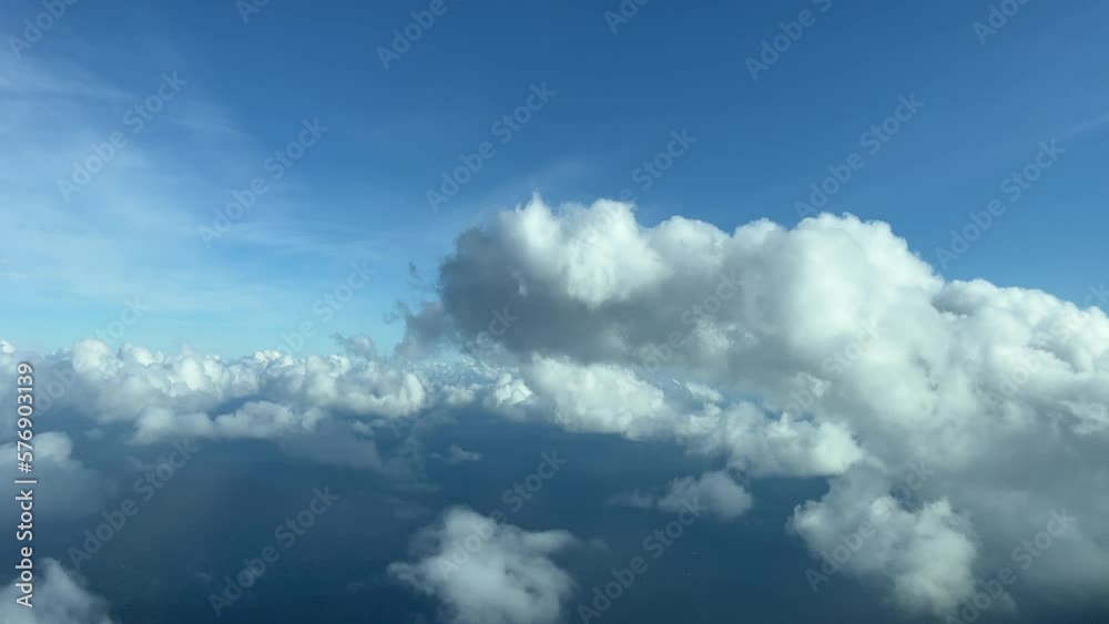 Flying through some tiny cumulus clouds, daylight. Pilot point of view, recorded from a jet cockpit flying at 5000m high. Flying through some tiny cumulus clouds, daylight. Pilot point of view, recorded from a jet cockpit flying at 5000m high.