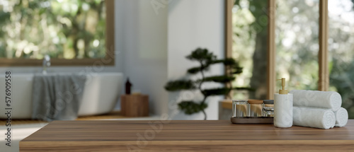 Wood tabletop with empty space over blurred modern bathroom with bathtub in background