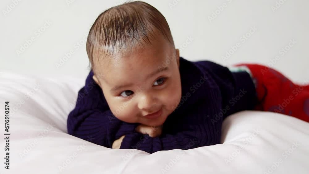 infant boy lying cute facial expression with white background at indoor infant boy lying cute facial expression with white background at indoor