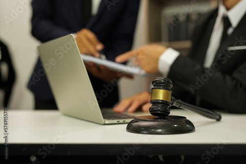 judge on wooden table And experienced lawyers meet with clients and give advice behind the scenes. legal services legal consulting concept