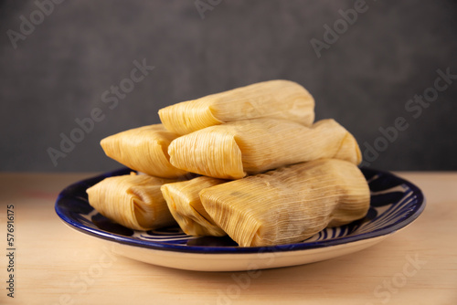 Tamales. Prehispanic dish typical of Mexico and some Latin American countries. Corn dough wrapped in corn leaves. The tamales are steamed. photo