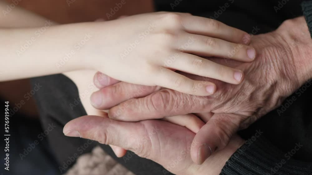hands of a child hugging the hands of an elderly man.selective focus. wrinkled hands of an old man stroking the hands of a child. intergenerational relationships in the family hands of a child hugging the hands of an elderly man.selective focus. wrinkled hands of an old man stroking the hands of a child. intergenerational relationships in the family