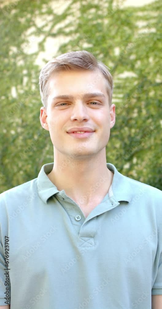Vertical video of portrait of happy caucasian man in garden Vertical video of portrait of happy caucasian man in garden