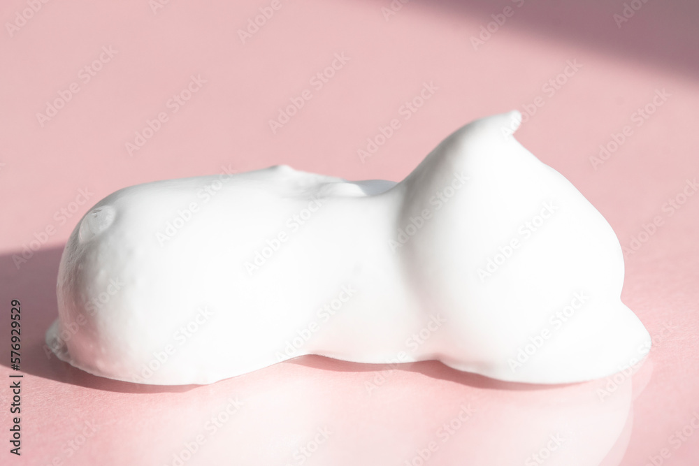 Drop of white cosmetic texture on a pink background, macro. Skin moisturizer, bubble bath, hair mask. Drop of white cosmetic texture on a pink background, macro. Skin moisturizer, bubble bath, hair mask.