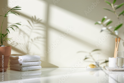 Various objects on a white tile background with warm sunlight shining through
