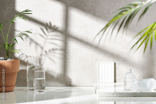 Various objects on a white tile background with warm sunlight shining through
