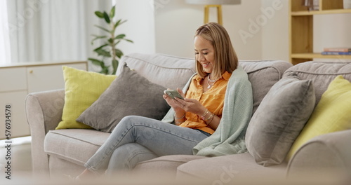 Relax, comfortable and phone with woman on sofa for break, browsing and social media. Technology, internet and happy with girl scrolling online in living room at home for message, calm and website