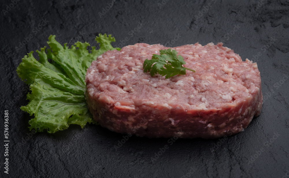Raw minced pork on marble board. Black background Raw minced pork on marble board. Black background