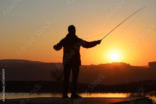 Silhouette of a fisherman at Sunrise