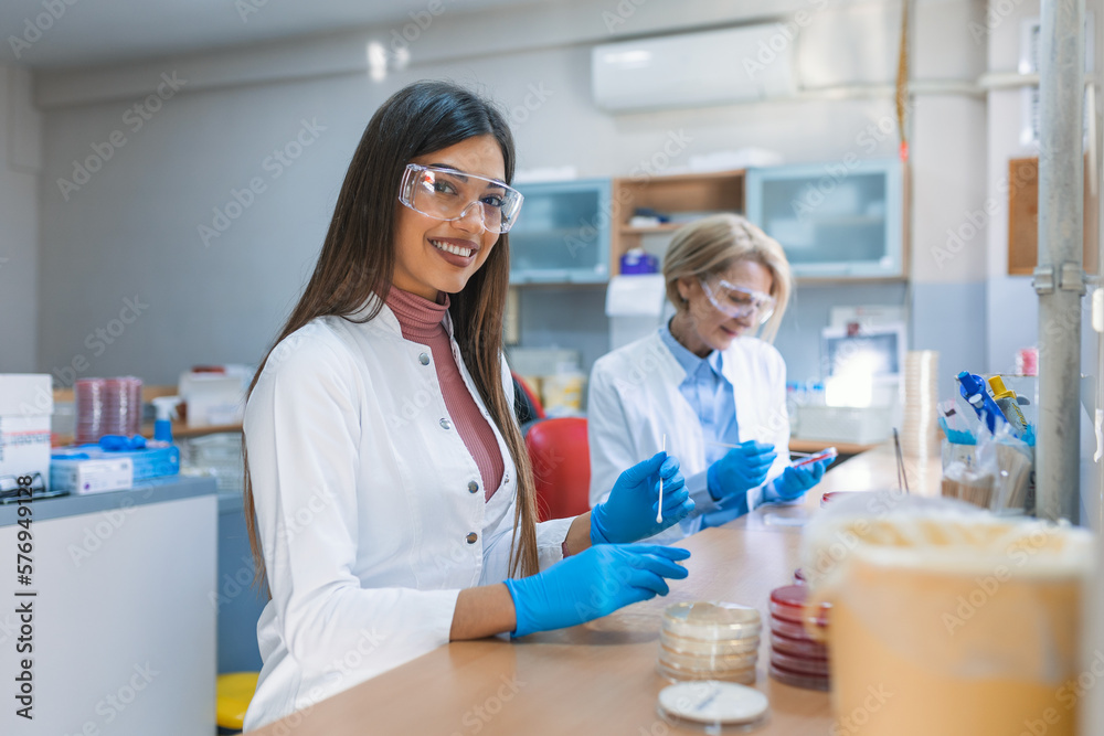 Scientist examining solution in petri dish at a laboratory. Lab