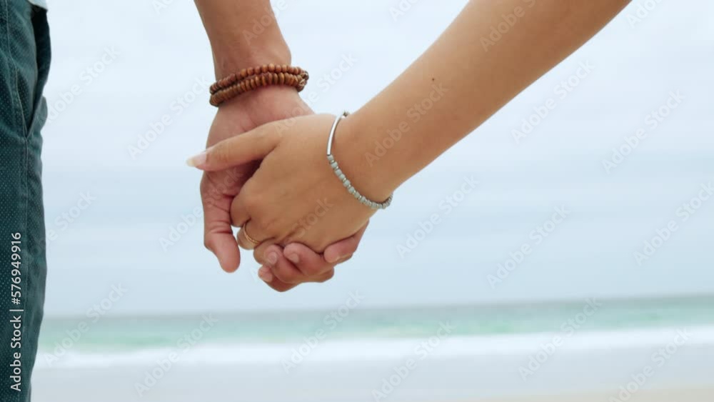 Back, couple and holding hands at beach, love and loyalty of save the date marriage. Closeup hand of man, woman and ocean with trust, support and peace for travel, freedom and care for life partner Back, couple and holding hands at beach, love and loyalty of save the date marriage. Closeup hand of man, woman and ocean with trust, support and peace for travel, freedom and care for life partner