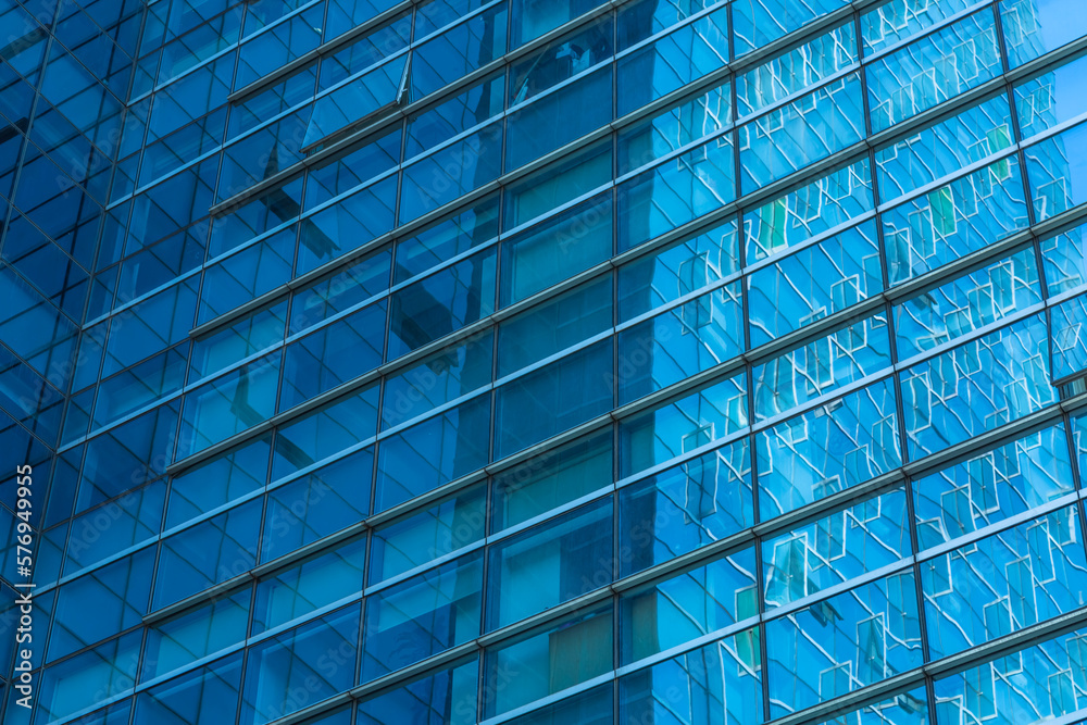 Obraz premium background of the glass modern office building.
