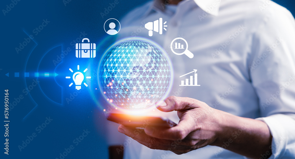 Businessman using smart phone with virtual business icons to improve success goals target Businessman using smart phone with virtual business icons to improve success goals target