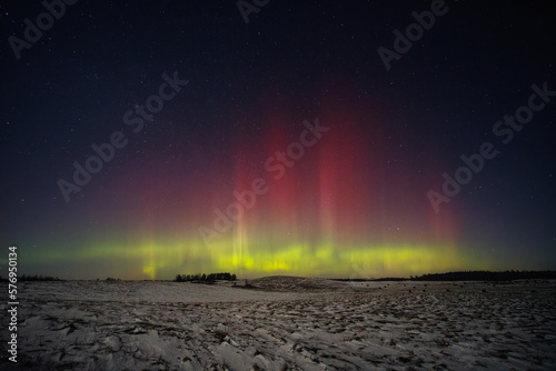 Northern lights - Aurora borealis dancing in the night sky. © lukjonis