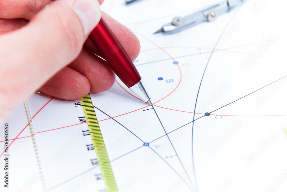 Professional architect working at his desk, measuring and estimating the building project Professional architect working at his desk, measuring and estimating the building project