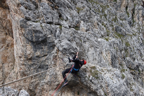 man hanging on rope dolomites panoramic views climbing outdoor europe