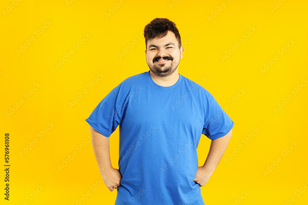 Concept of people, young fat man on yellow background Concept of people, young fat man on yellow background