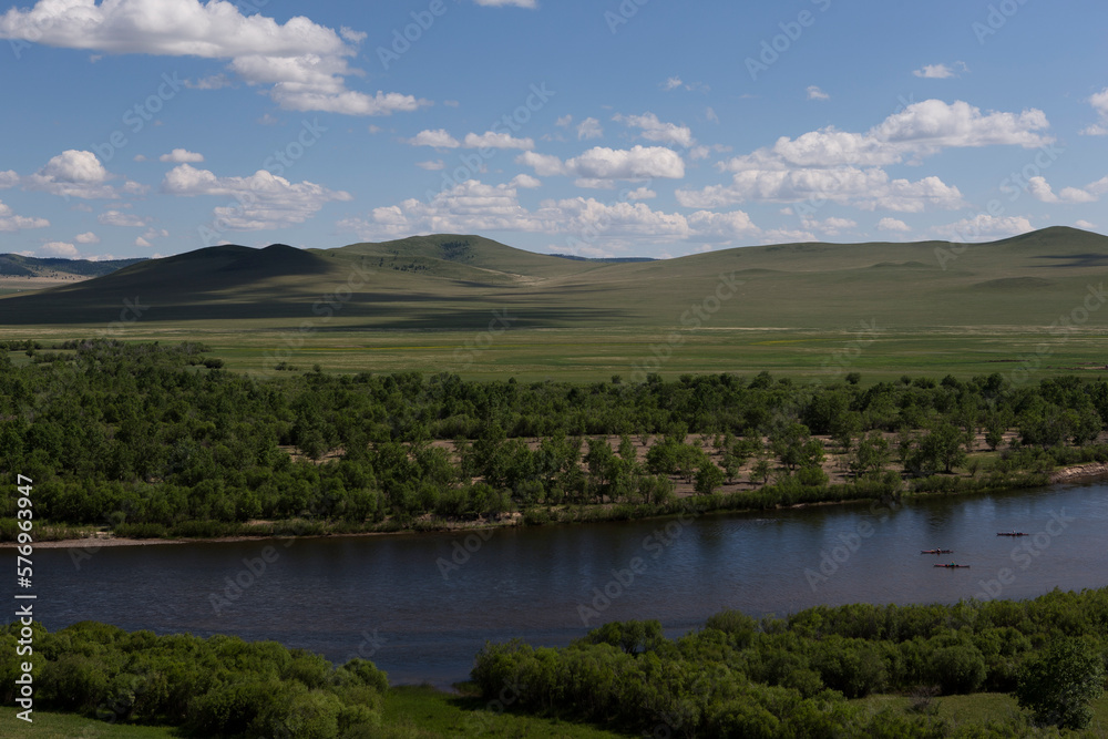 Three women paddle their kayaks on the Onon river in northern Mongolia. Three women paddle their kayaks on the Onon river in northern Mongolia.